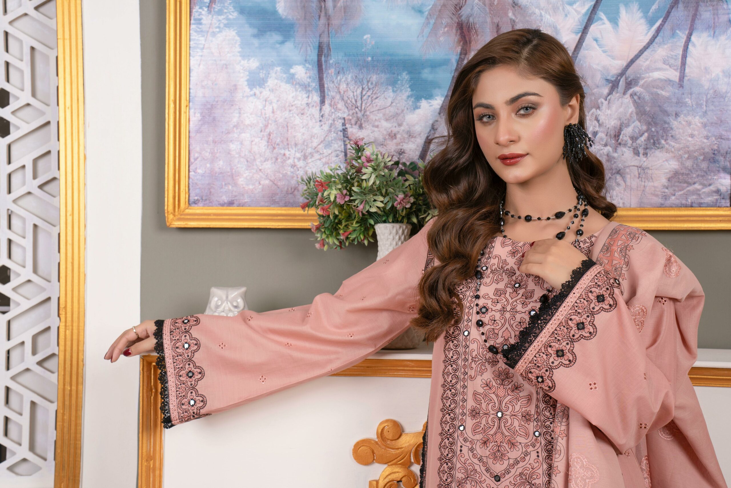 Stunning portrait of a young woman in elegant embroidered attire, showcasing modern fashion.